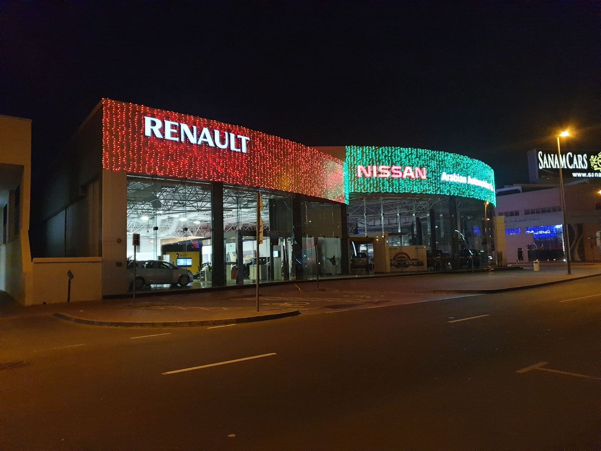 Festive lighting across a showroom facade at night