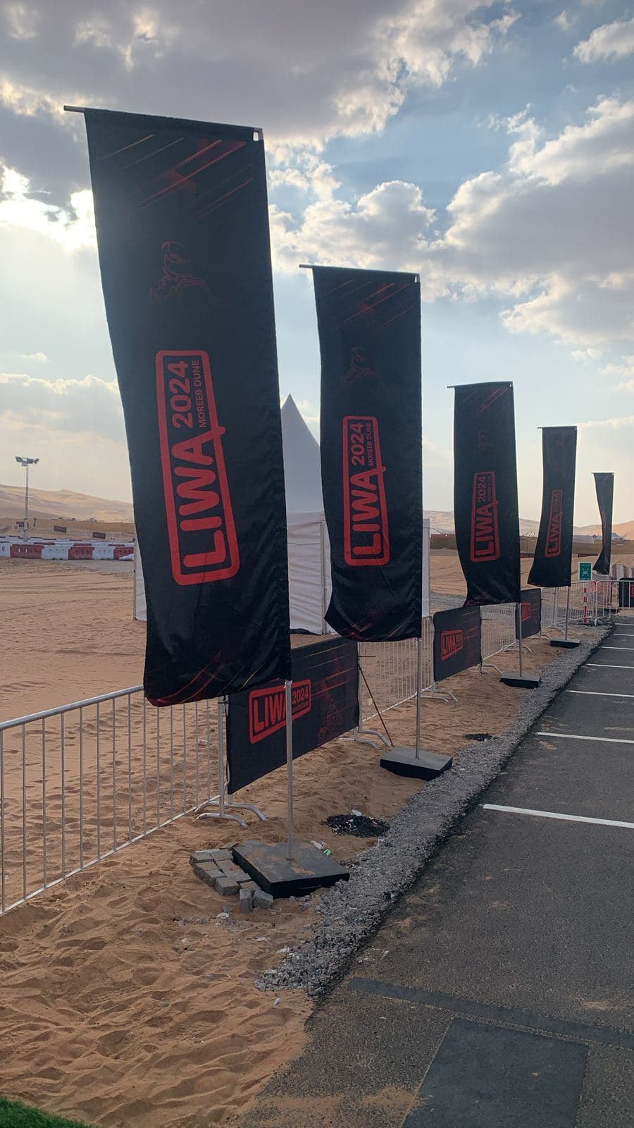 Black blade flags installed at a desert event site