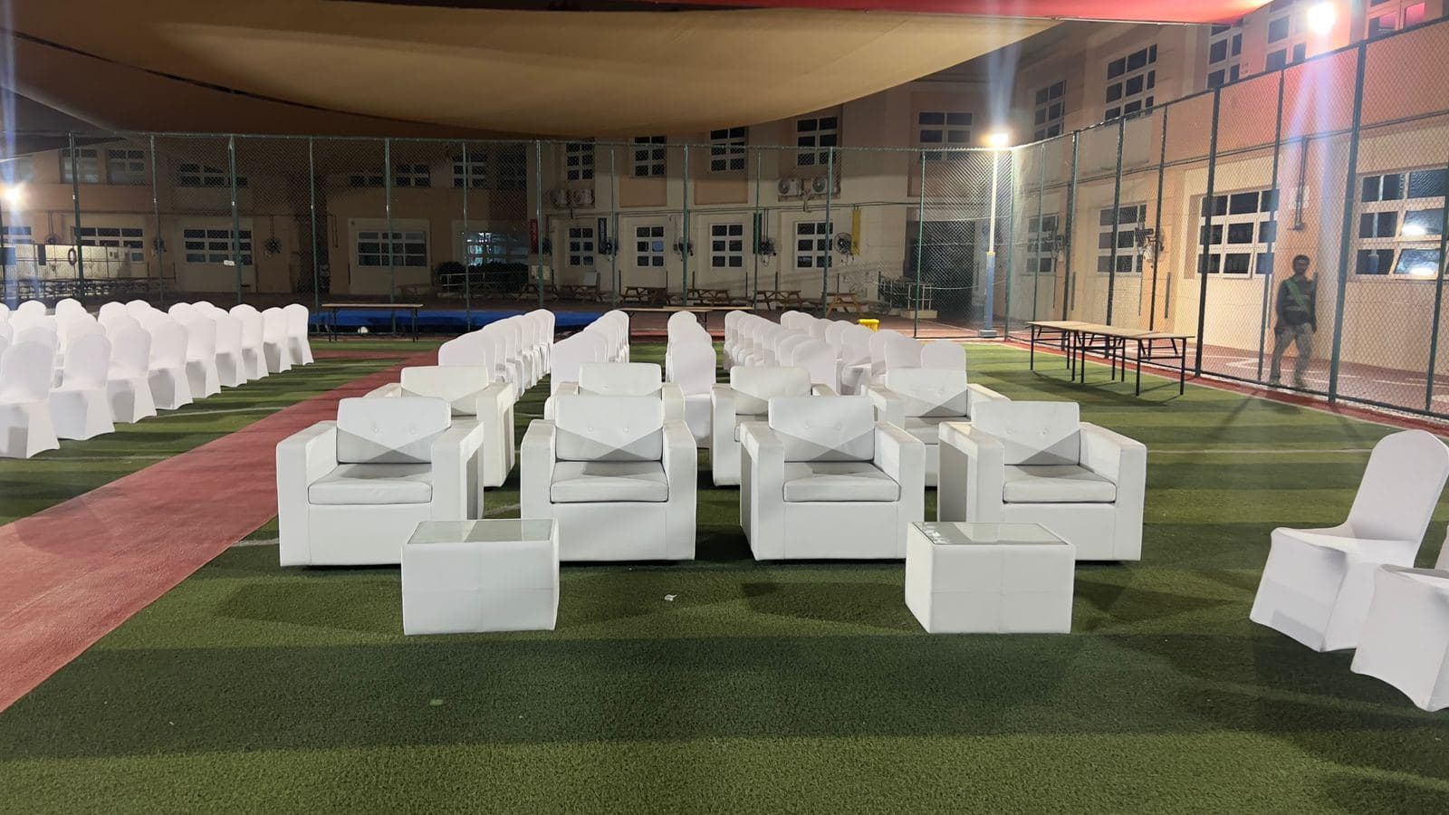 White lounge furniture arranged inside an event tent