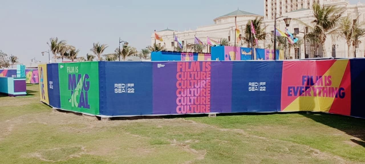 Printed fence wraps around a festival site