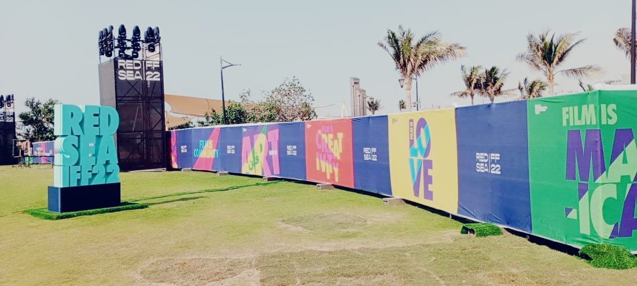 Temporary fencing wrapped in colourful festival graphics