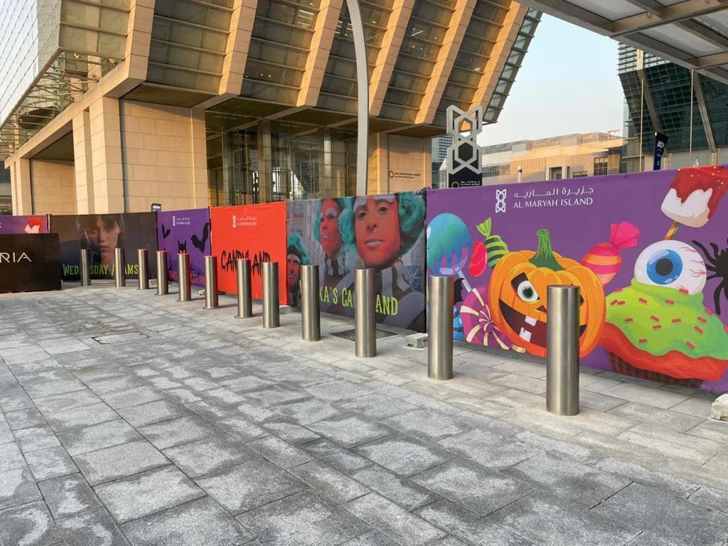 Printed fence graphics with seasonal artwork outside a mall