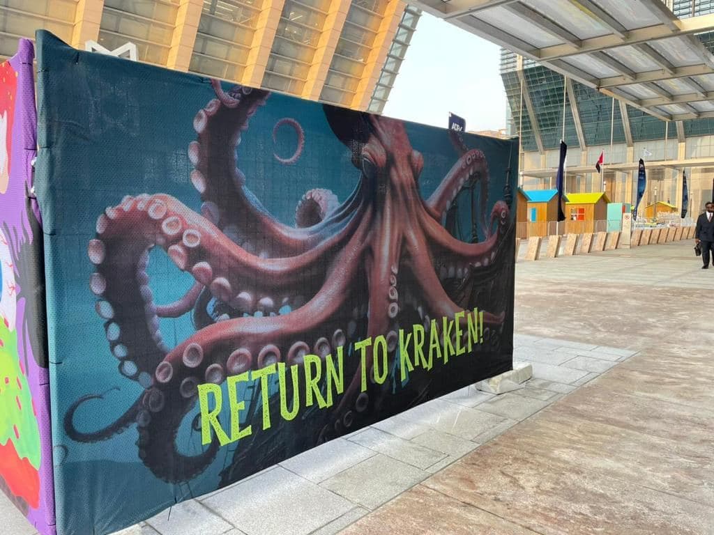 A fence wrap printed with large illustrated artwork