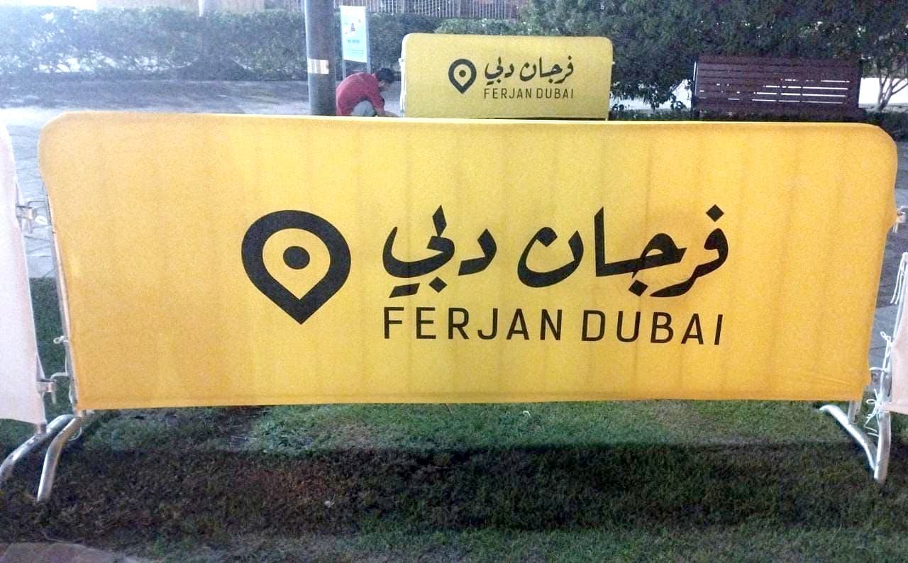A crowd-control barrier wrapped in a printed yellow cover