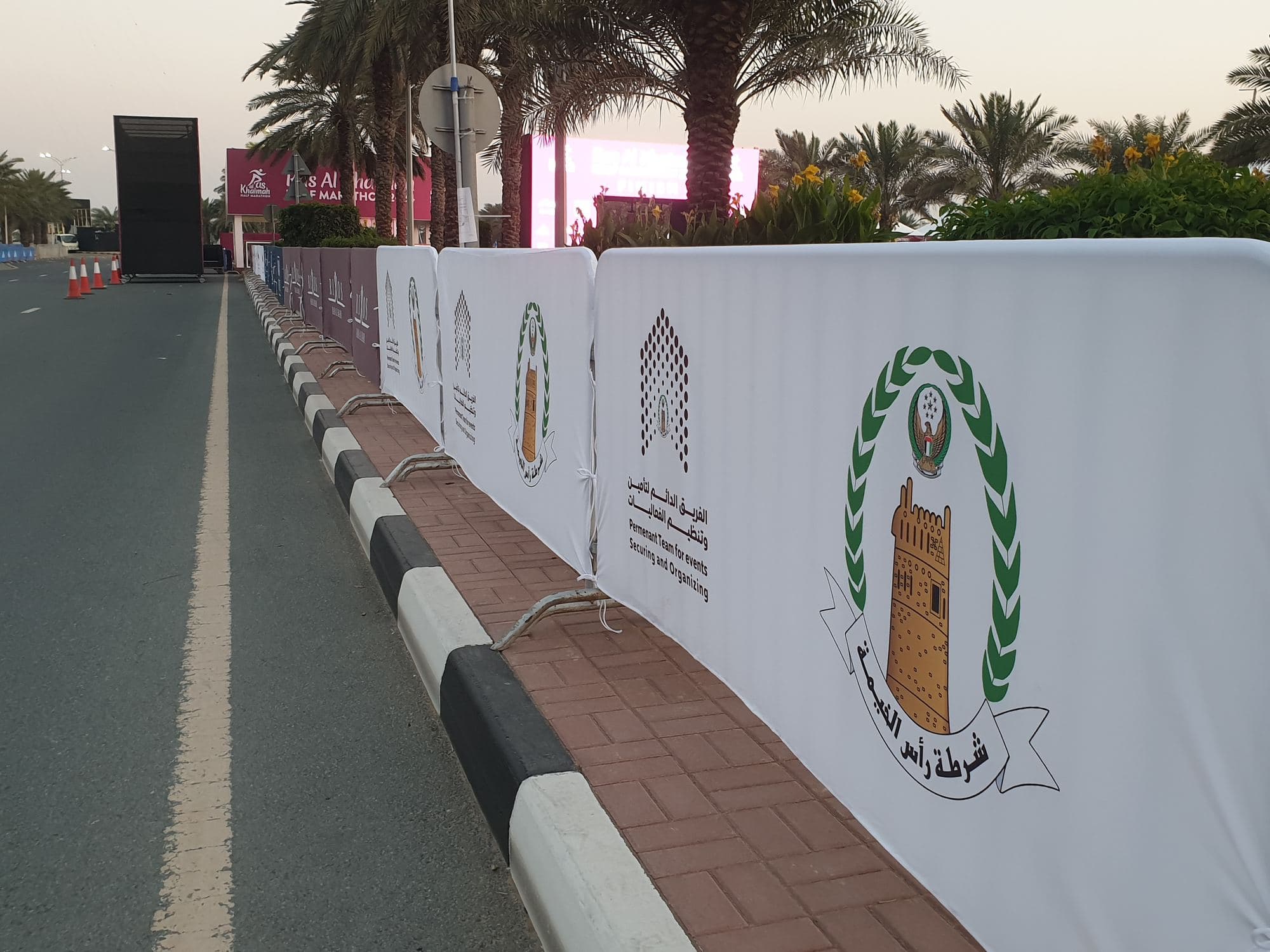 Barrier covers printed with an emblem along a footpath