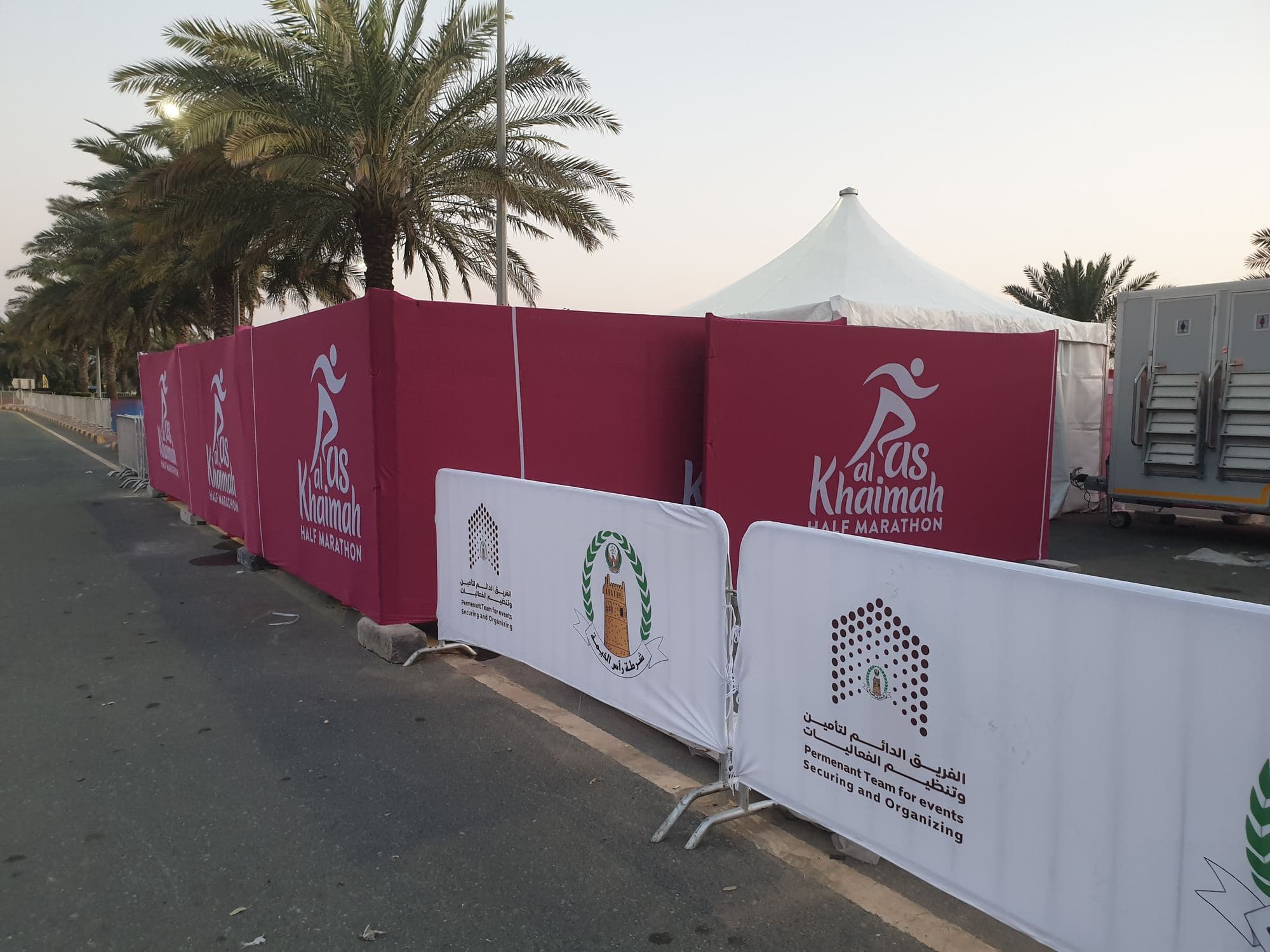 Branded barrier covers and fencing set up along an event route