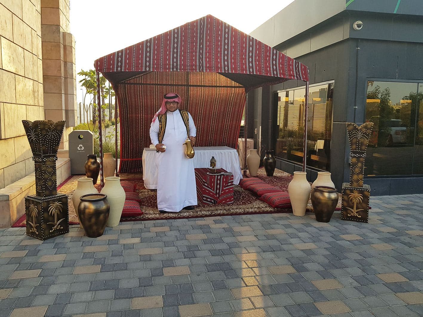 A traditional Arabic majlis tent set up with cushions and lanterns
