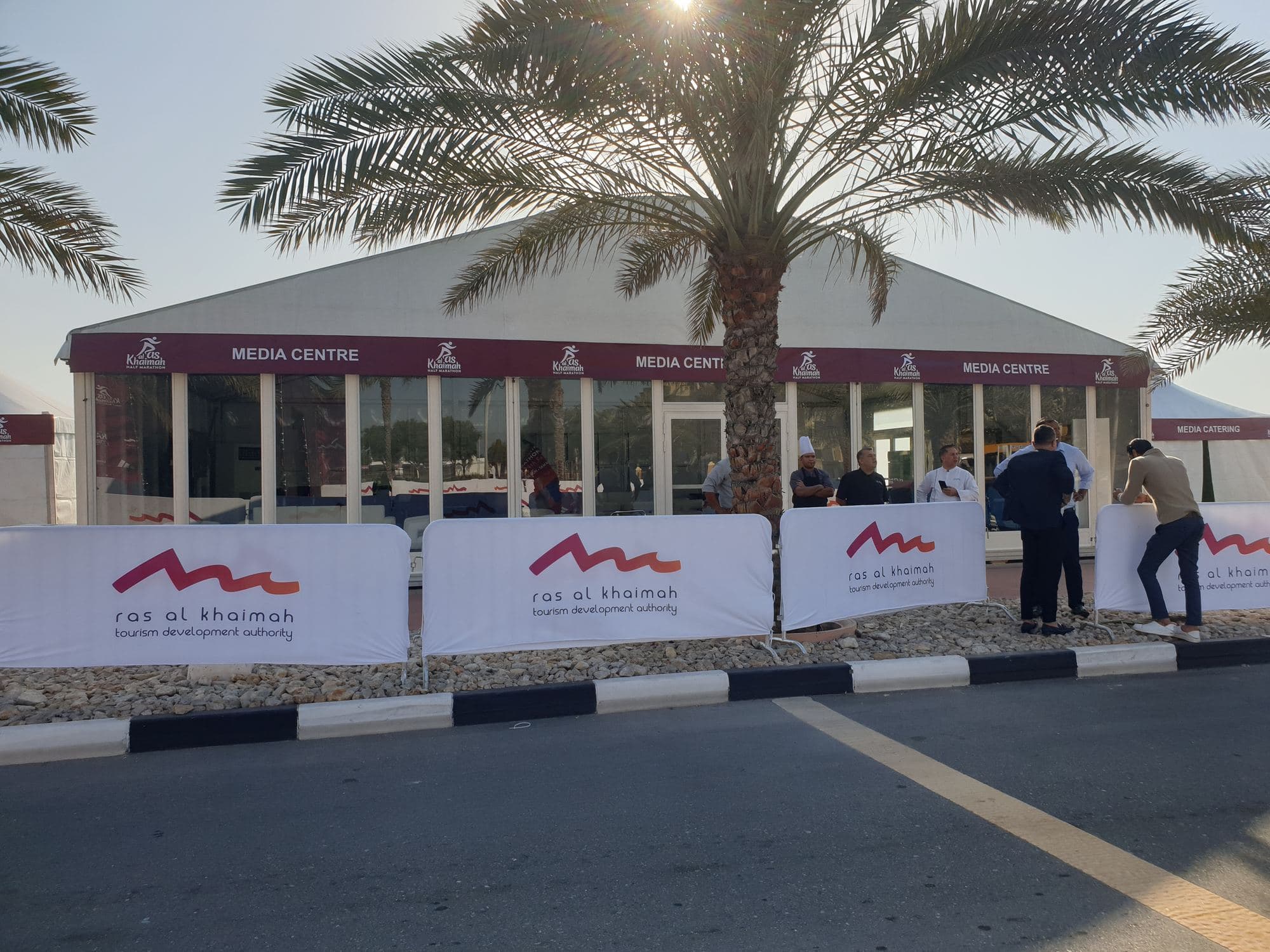 A branded marquee tent with barrier covers at an event site