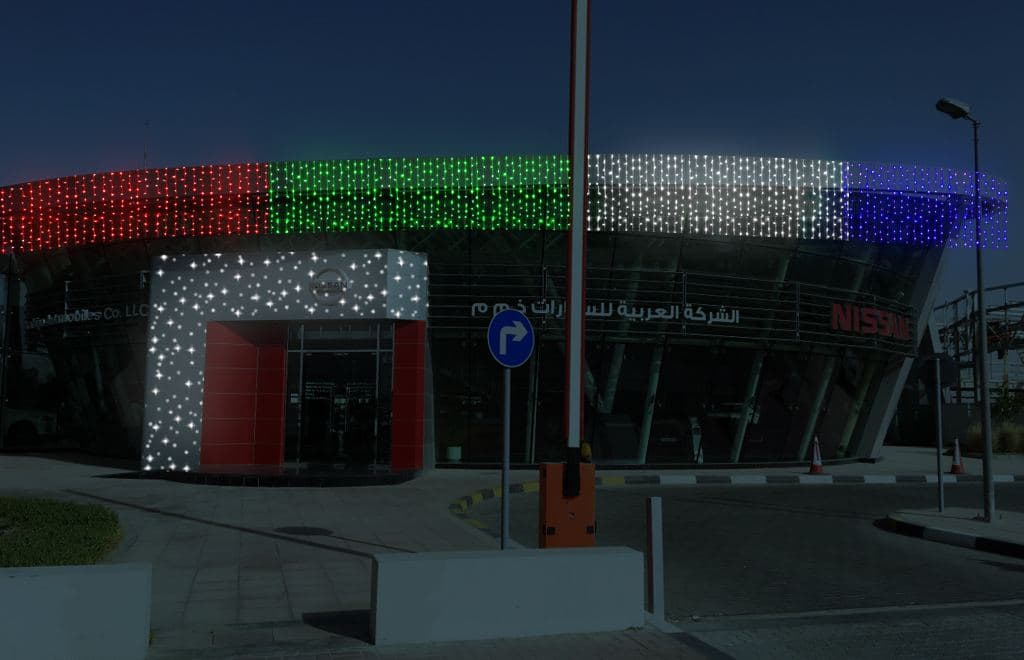 A showroom entrance decorated with festive lights