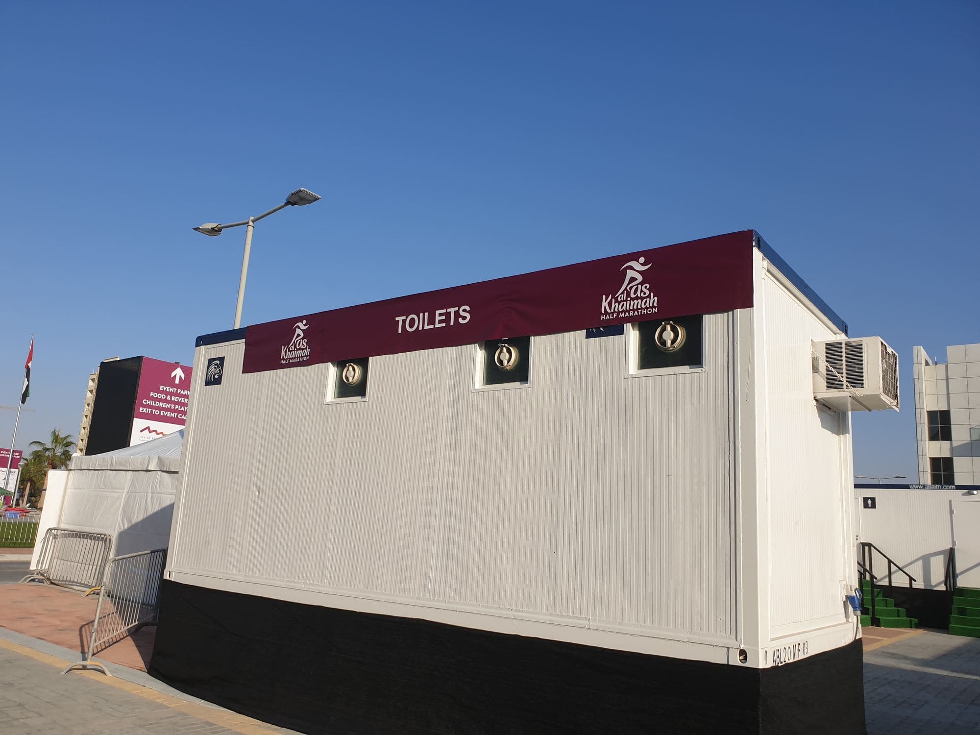 A branded portable cabin structure at an event site