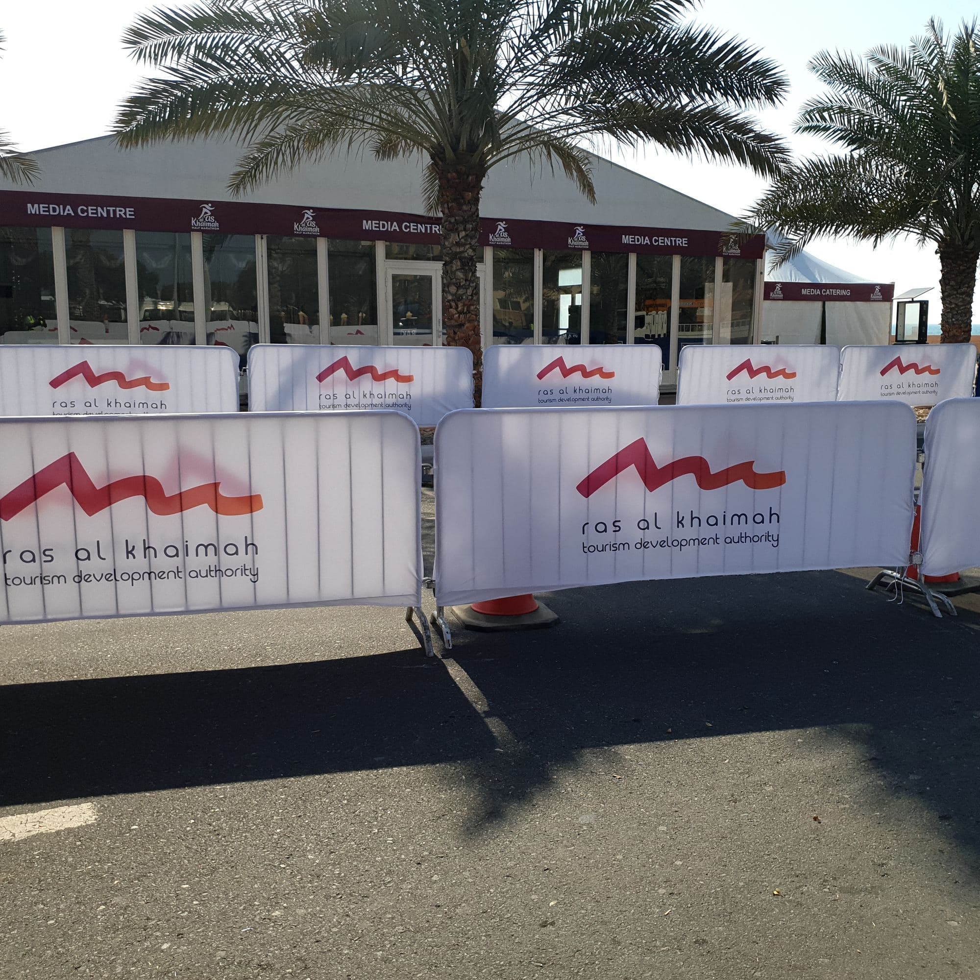A marquee tent behind branded barrier covers