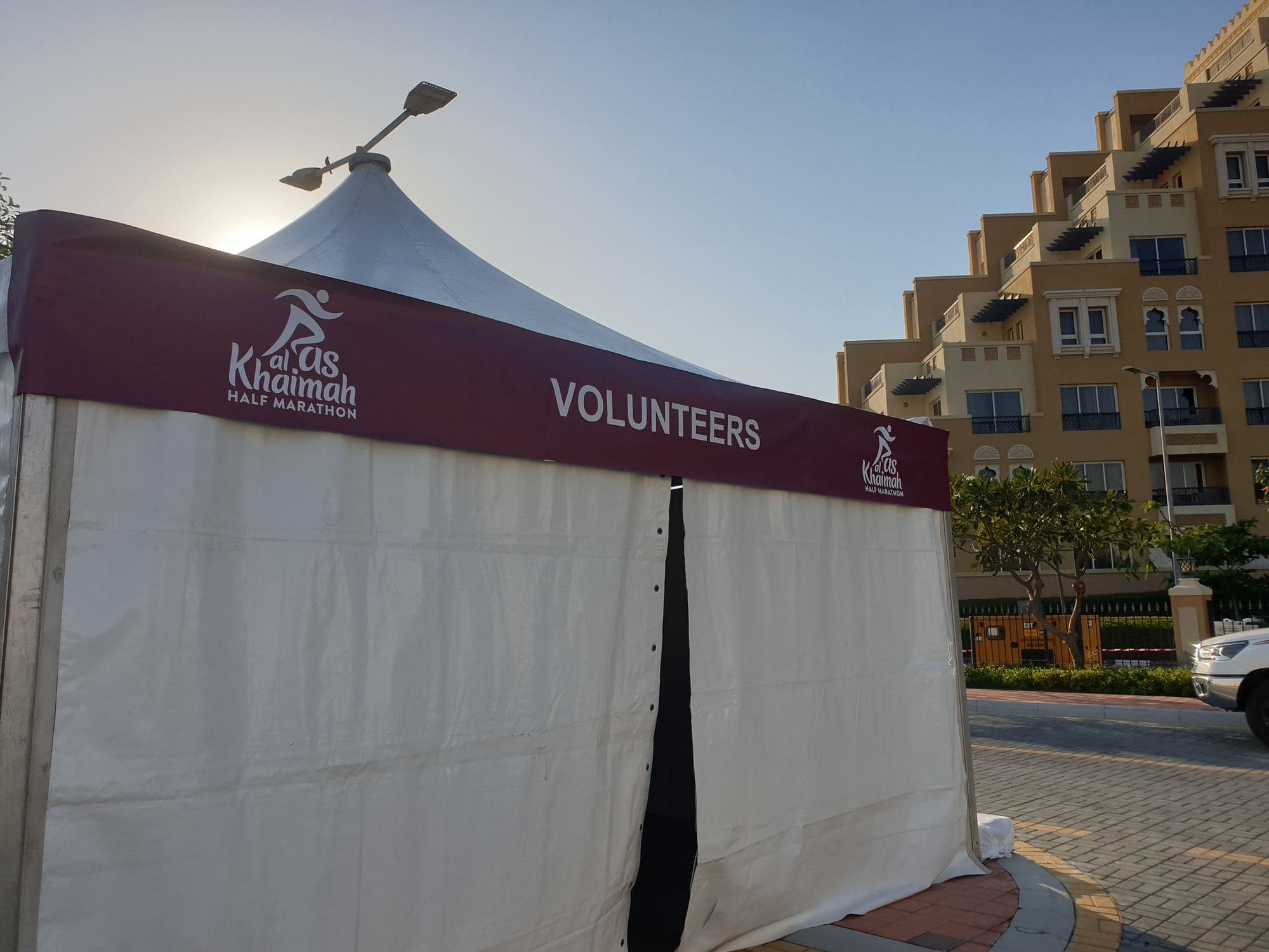 A branded peak tent set up as a volunteers area